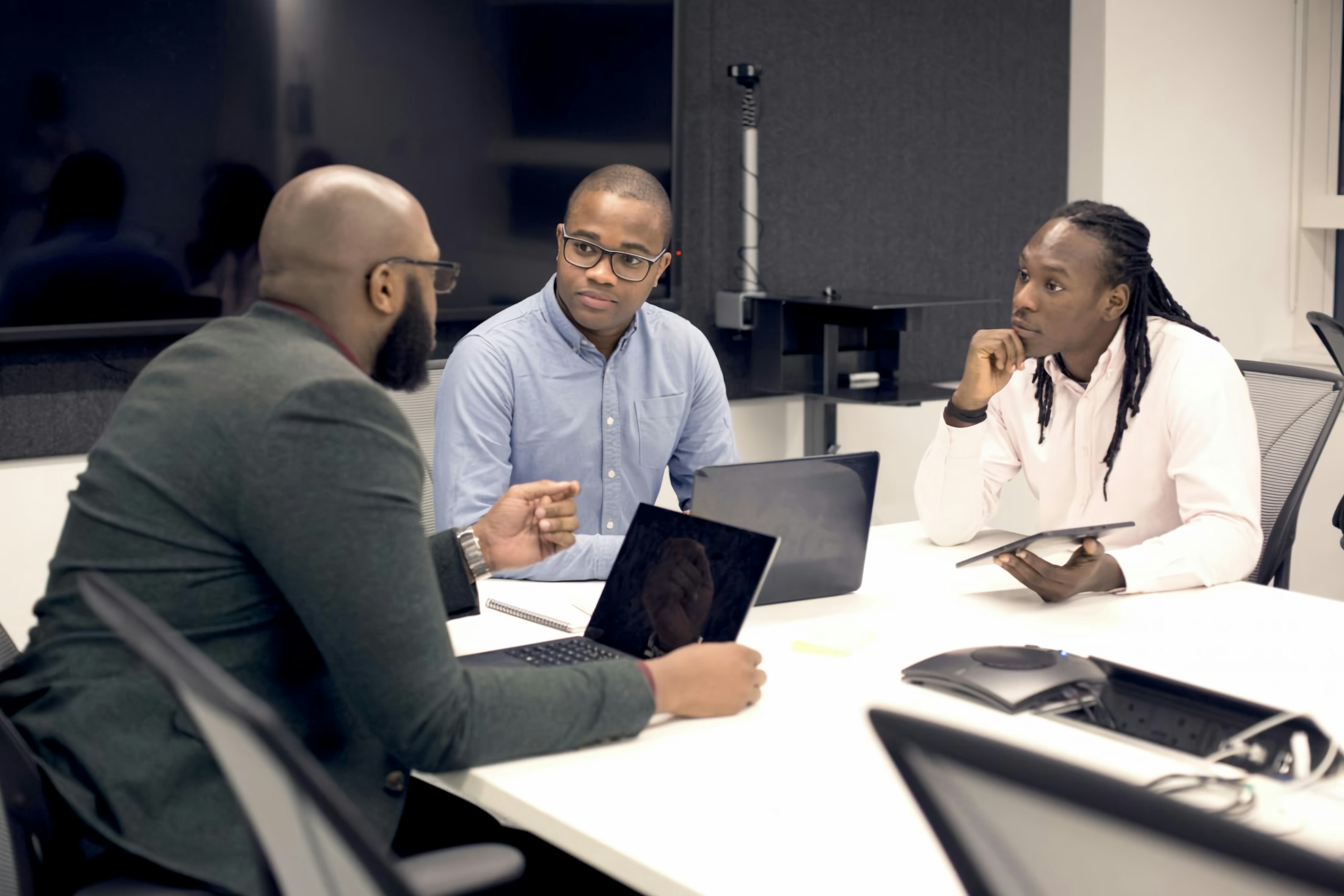 Black healthcare operations leaders reviewing a facility capacity board